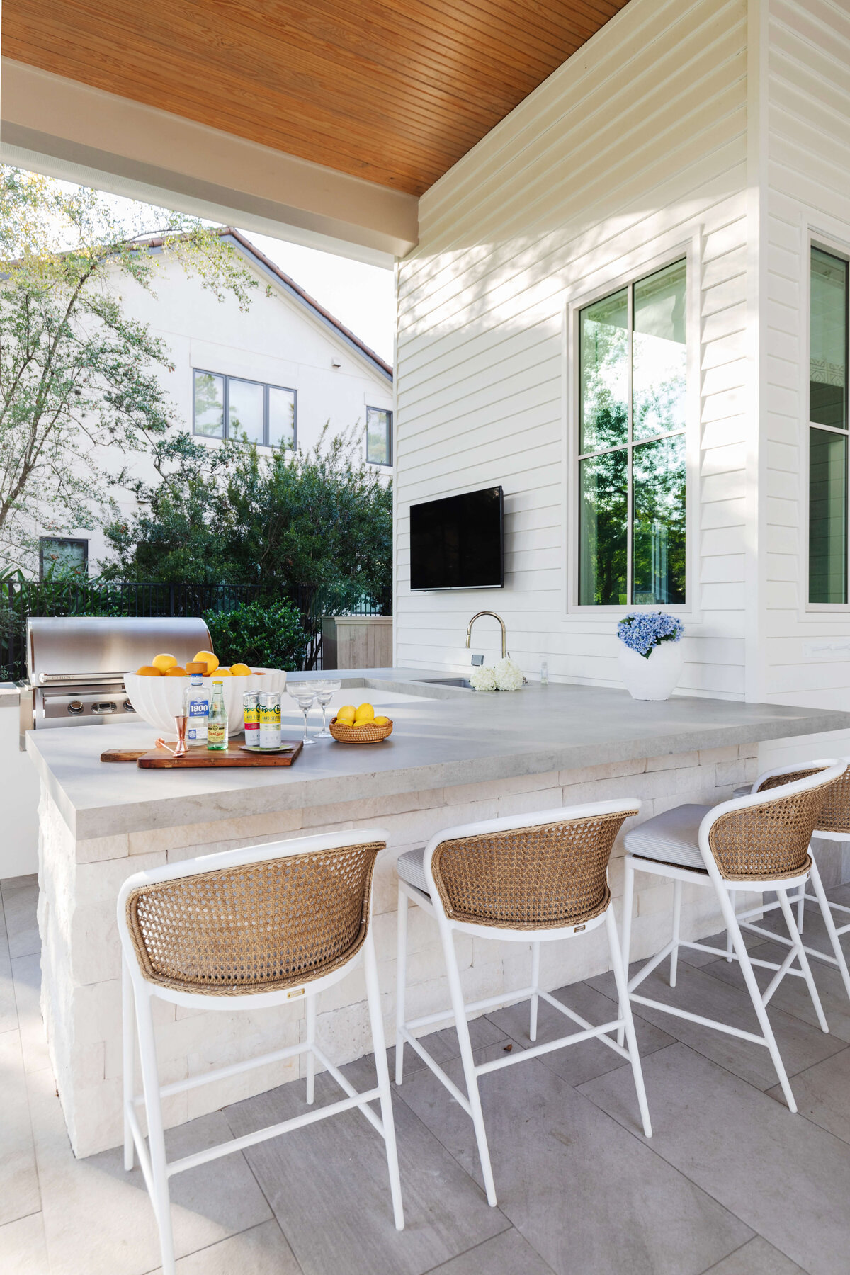 oyster creek studios memorial new build outdoor bar with grill white stools and tv