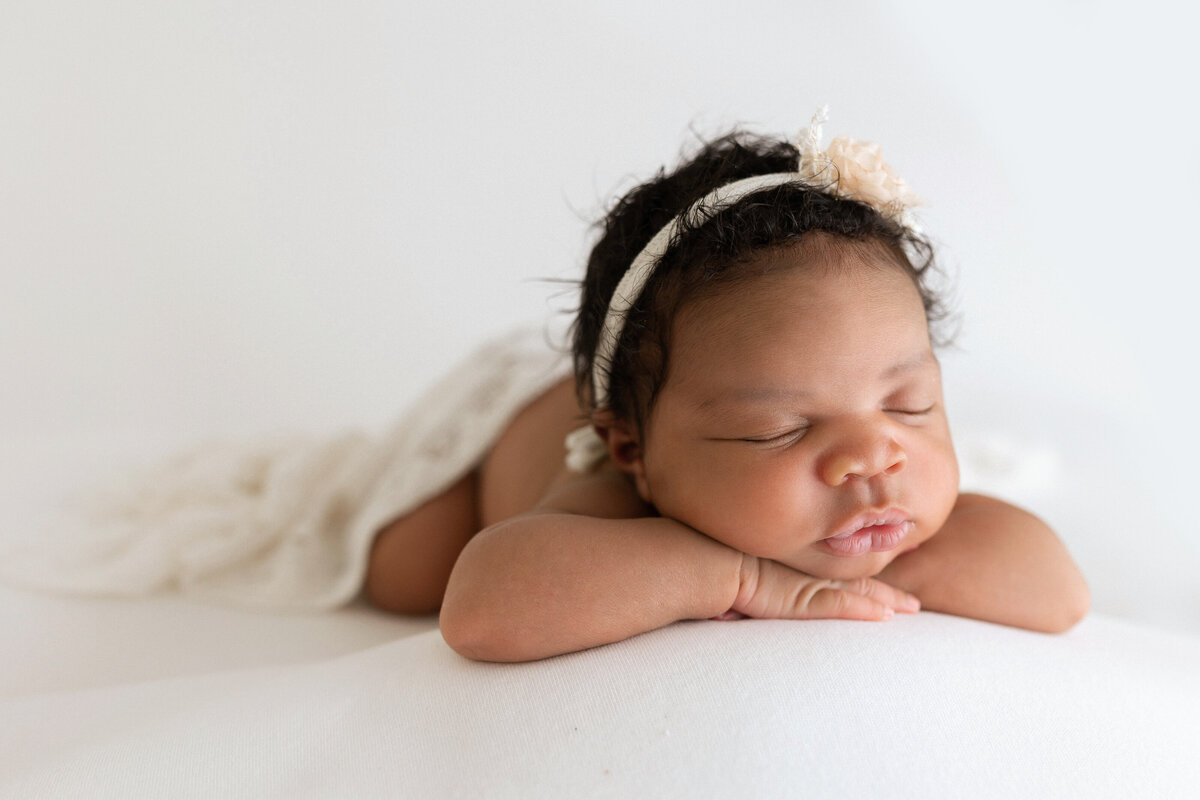 baby with head resting on hands