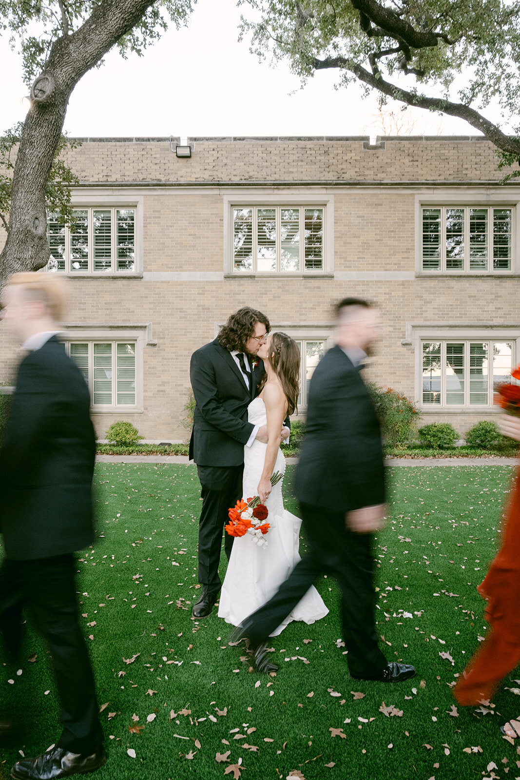 Couple smiling and holding hands during wedding recessional surrounded by guests in San Antonio