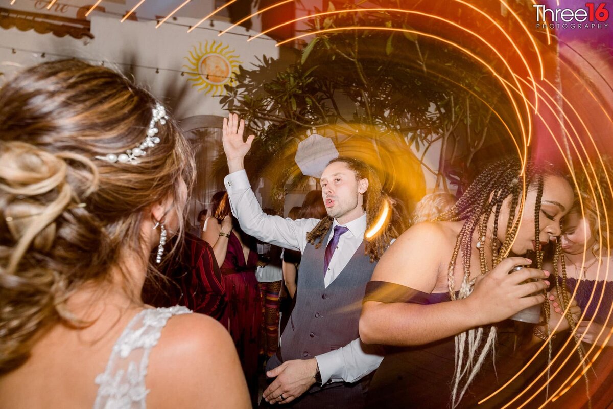 Groom dances with his Bride amongst others