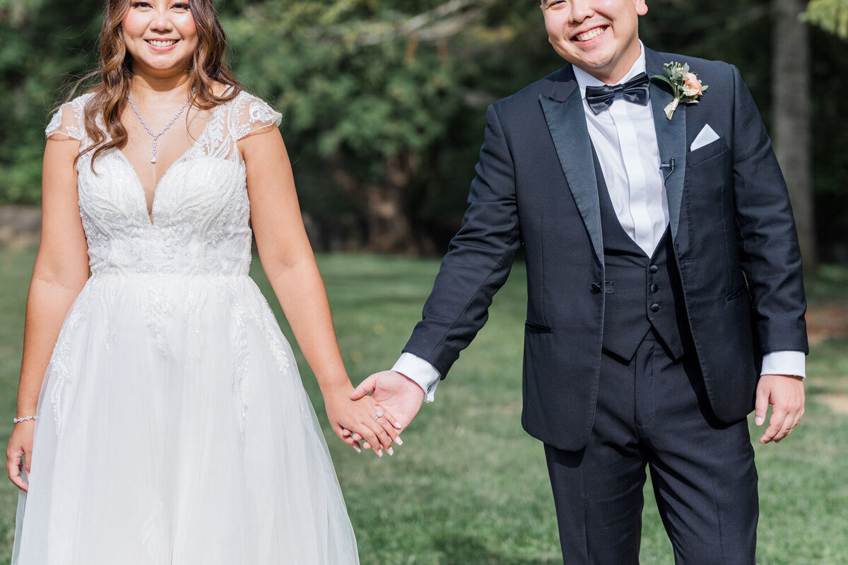 Wedding couple holding each others hands 