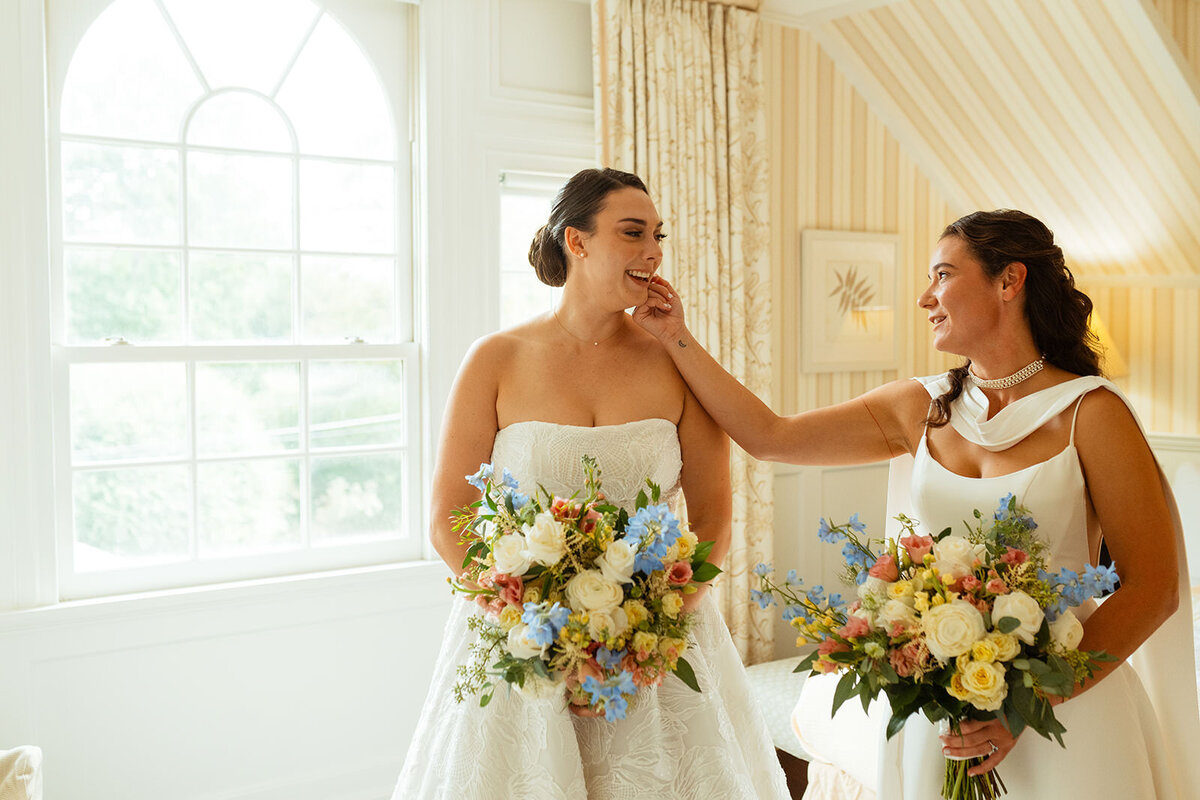 Bride holding other brides face