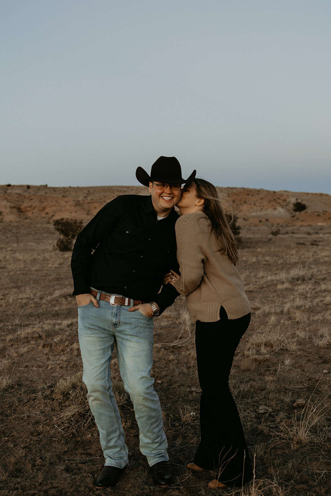 engaged couple being silly in the desert