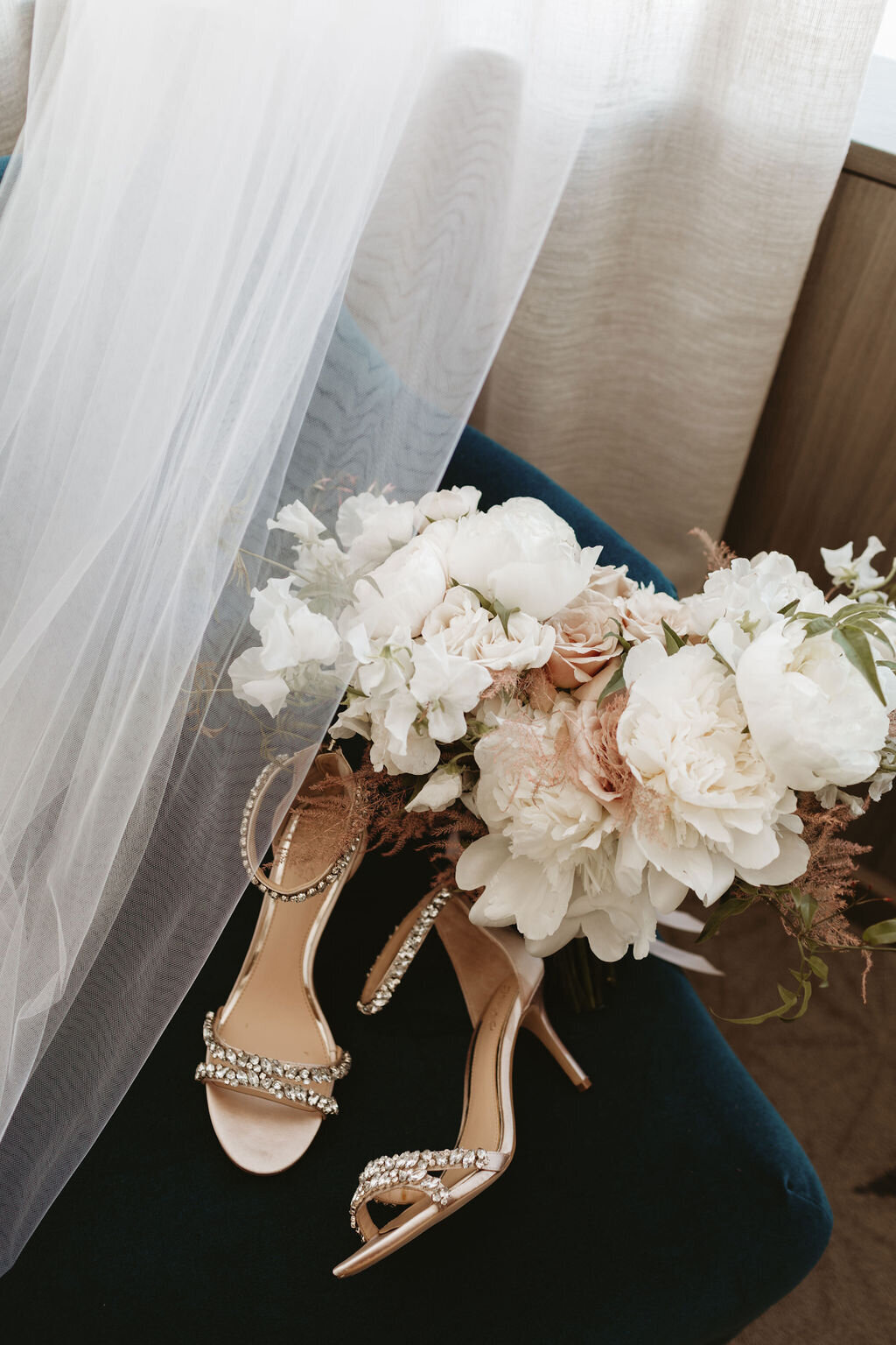 Bride's wedding shoes and bouquet.
