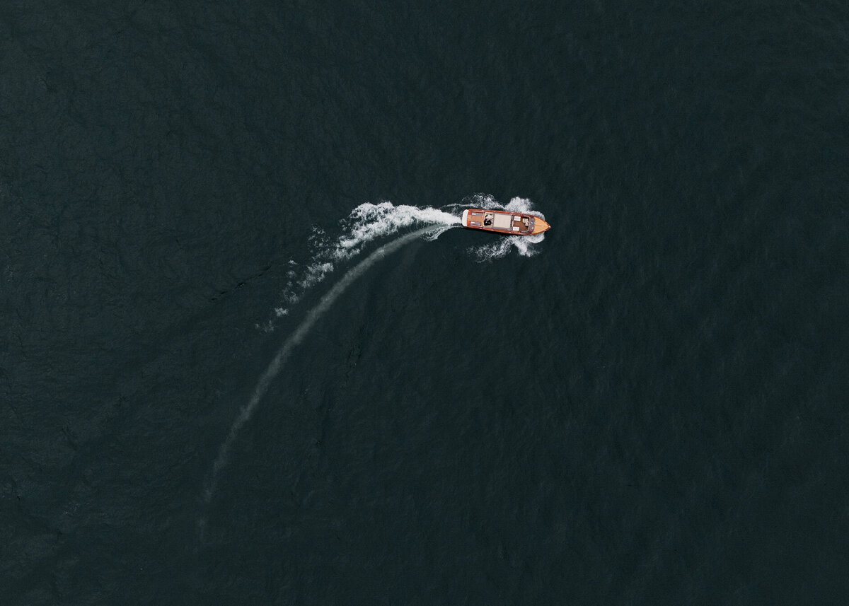 drone view of lake como boat ride wedding