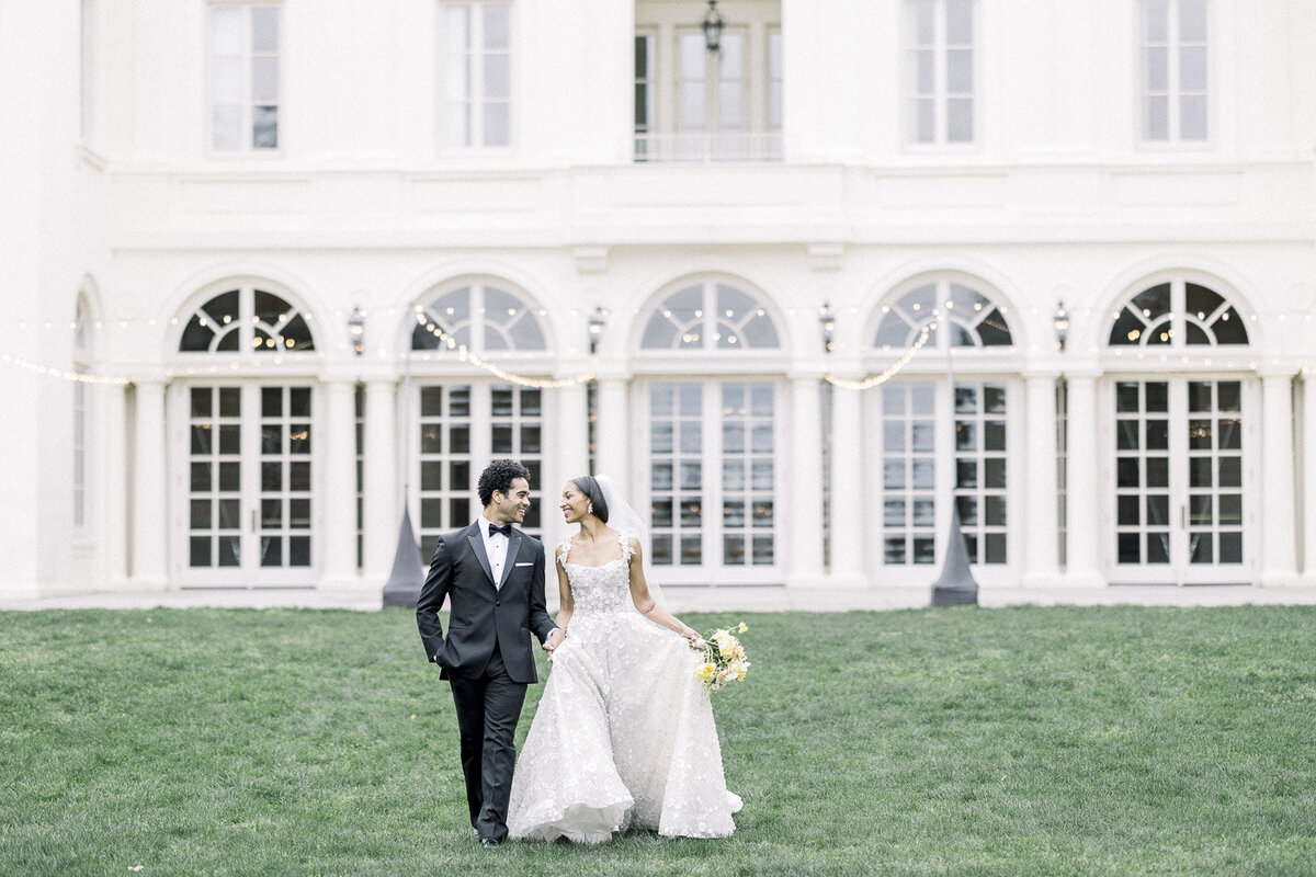 a bride and groom walking on the lawn of Wadsworth Mansion