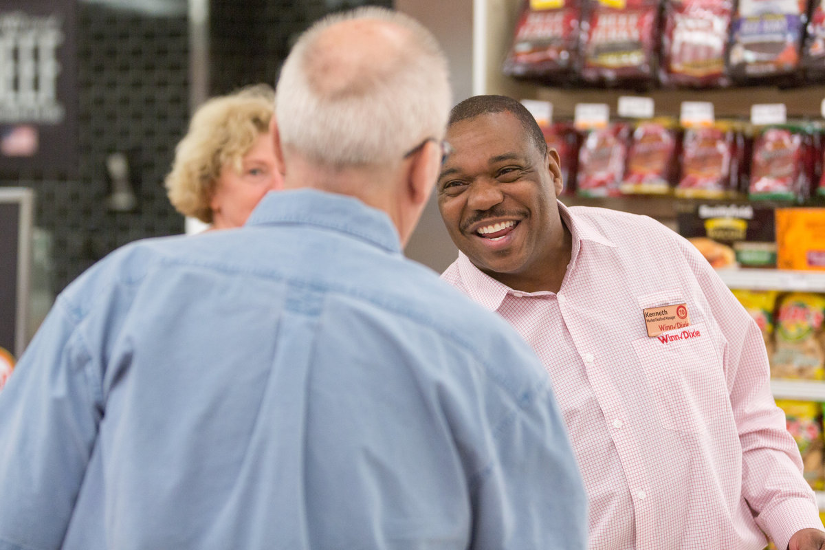 Customer and employee interacting during a grand opening.