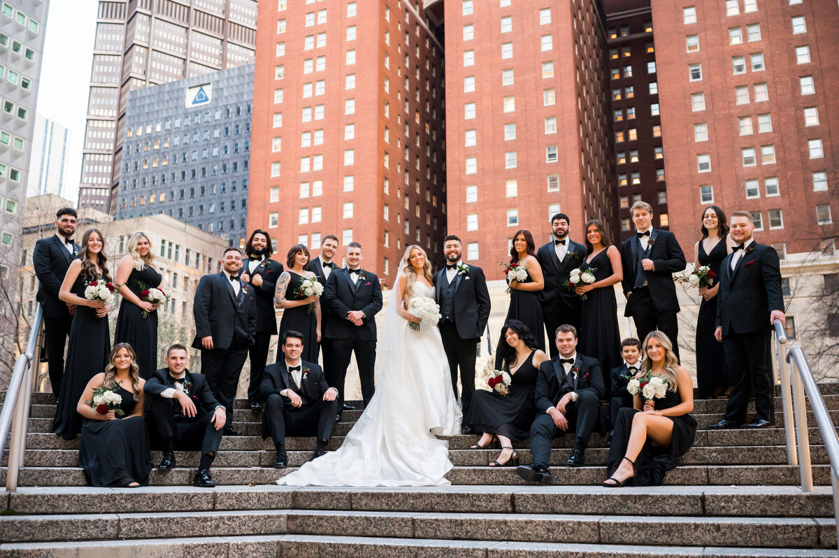 wedding party posing for fun photo outside of the omni hotel pittsburgh