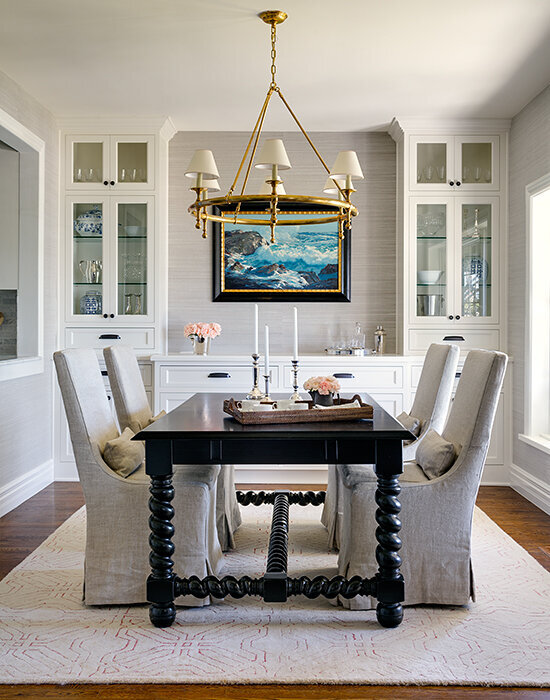 Dining-room-with-candelabra-style-chandelier-aged-brass-and-large-black-dining-table