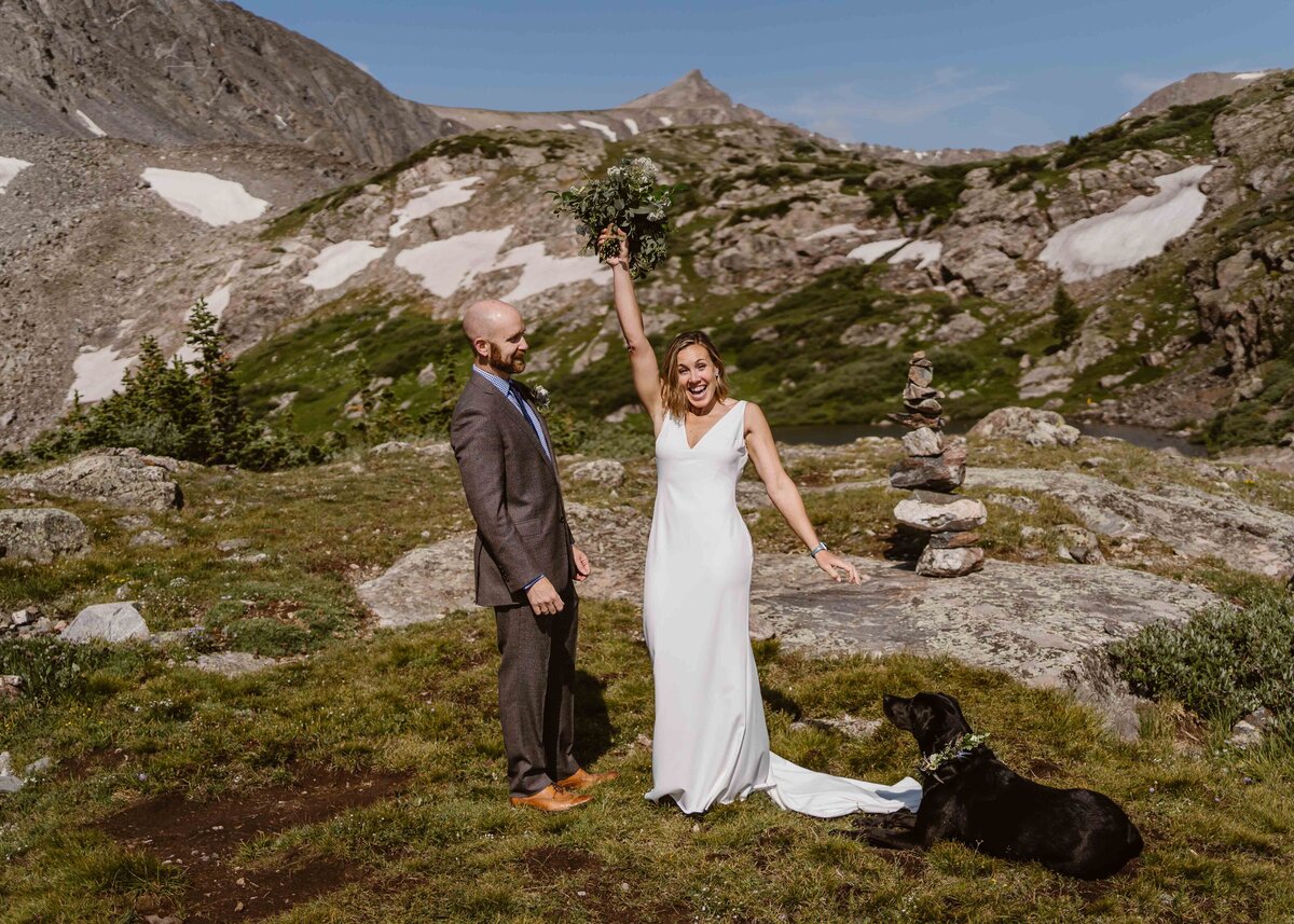  Mohawk Lakes Breckenridge Colorado elopement with couple celebrating with alpine lake and mountains in the background.