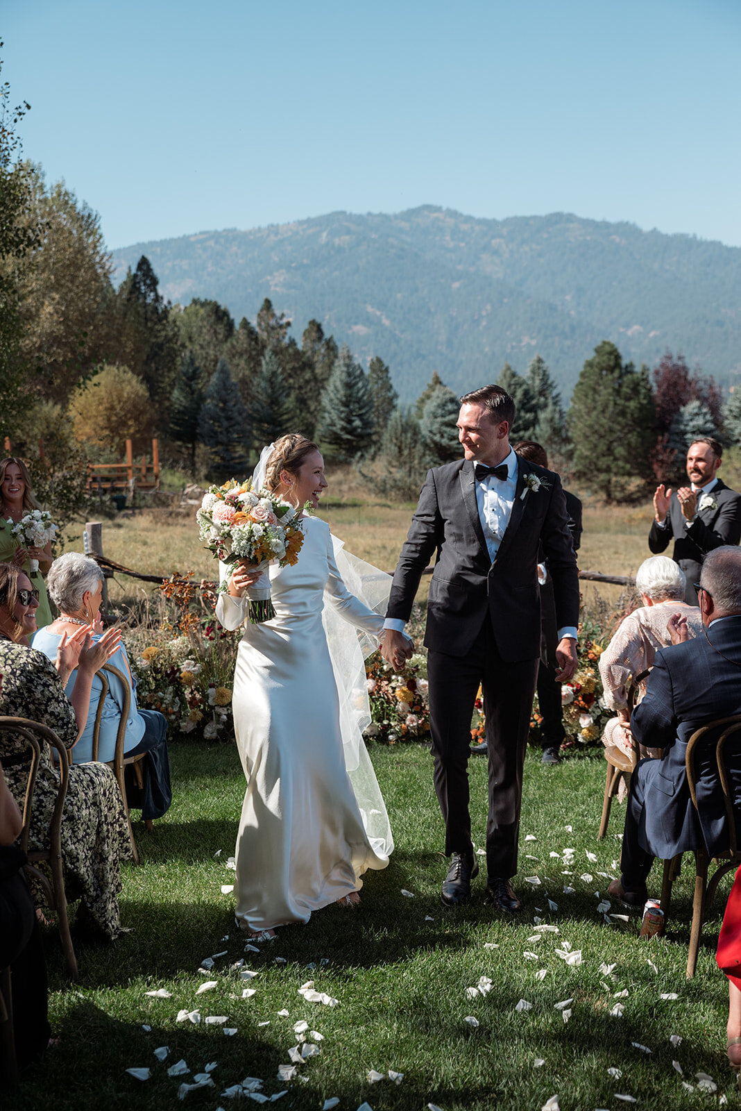 A bride and groom hold hands at their Boise Idaho Wedding.