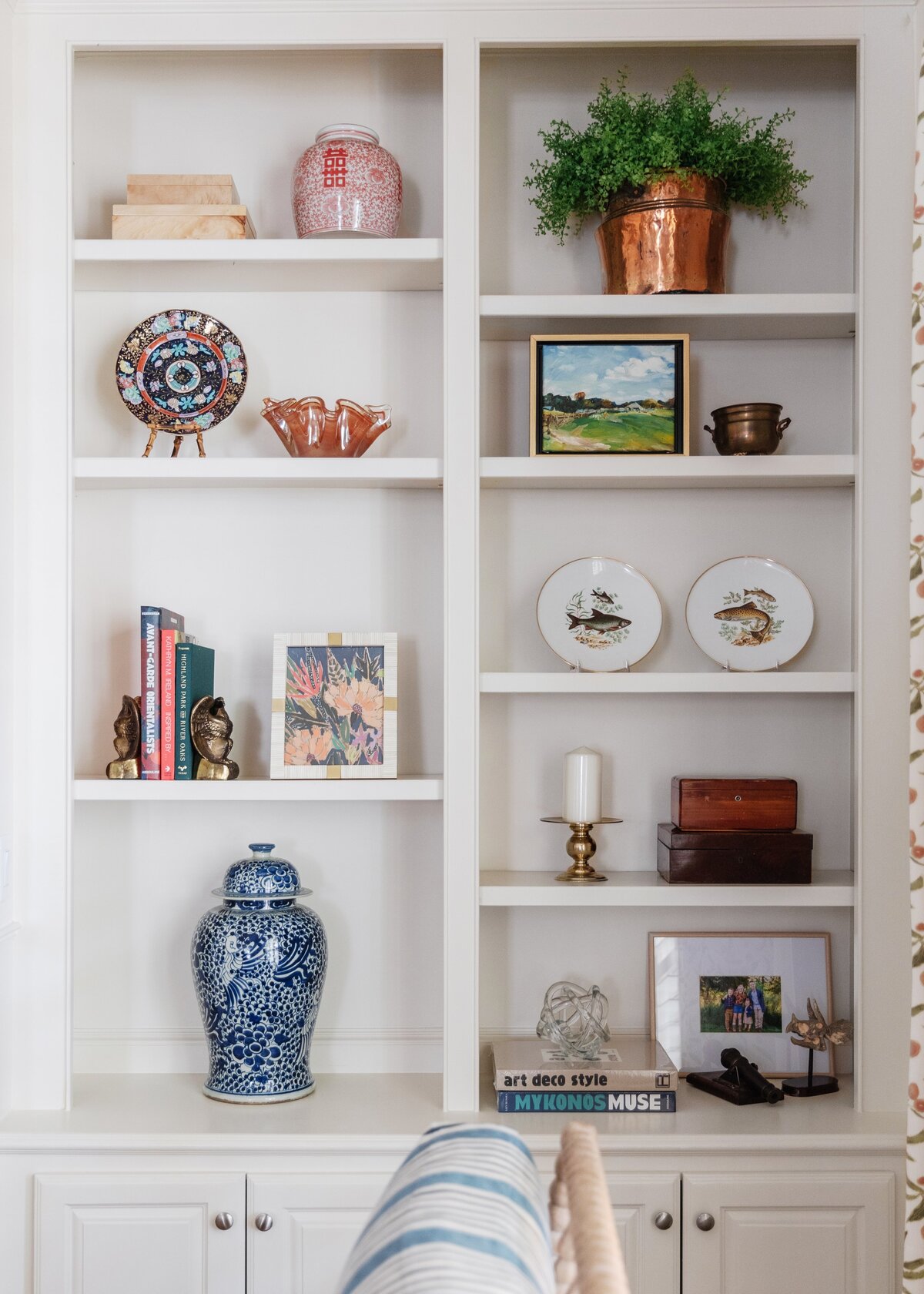 oyster creek studios oak forest remodel white shelves with vase plates and artwork in living room