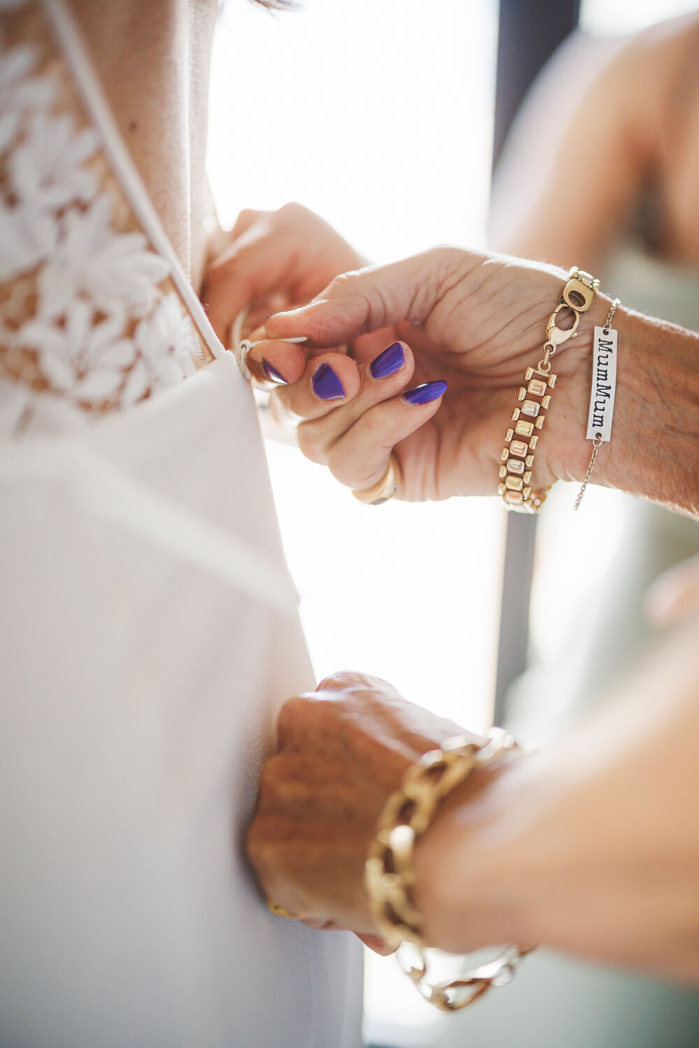 Mom fixing brides wedding dress
