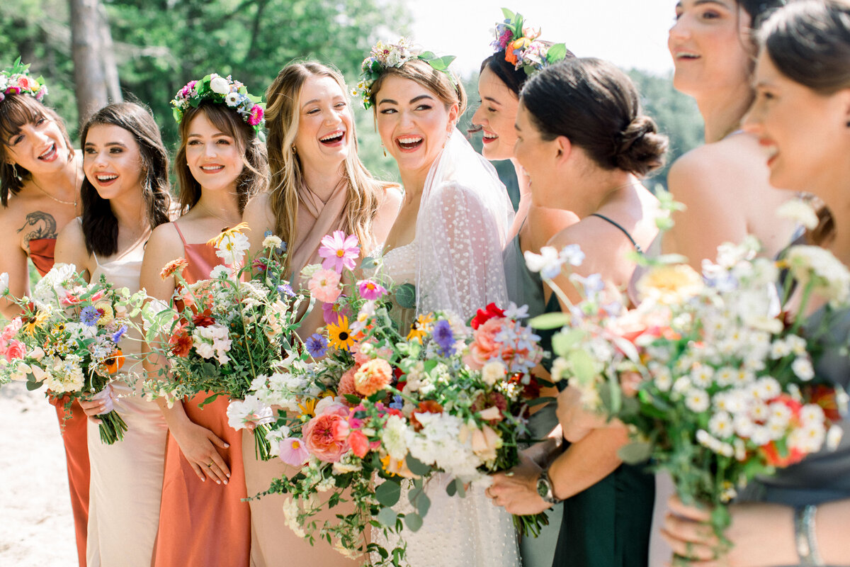 bride with bridesmaids at A colorful private lakeside wedding in New Hampshire