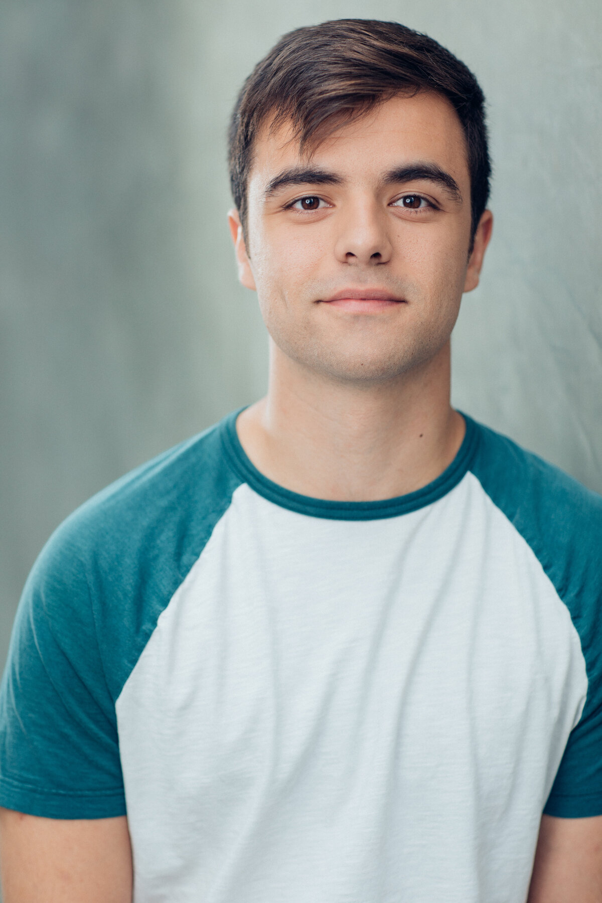 Young Man Wearing White and Green Round Neck Shirt Headshot in LA