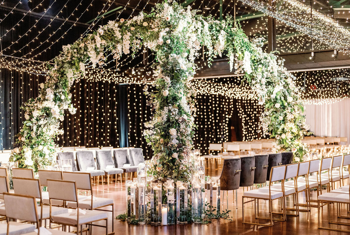 A close up of the floral arch and chairs for the wedding venue. 