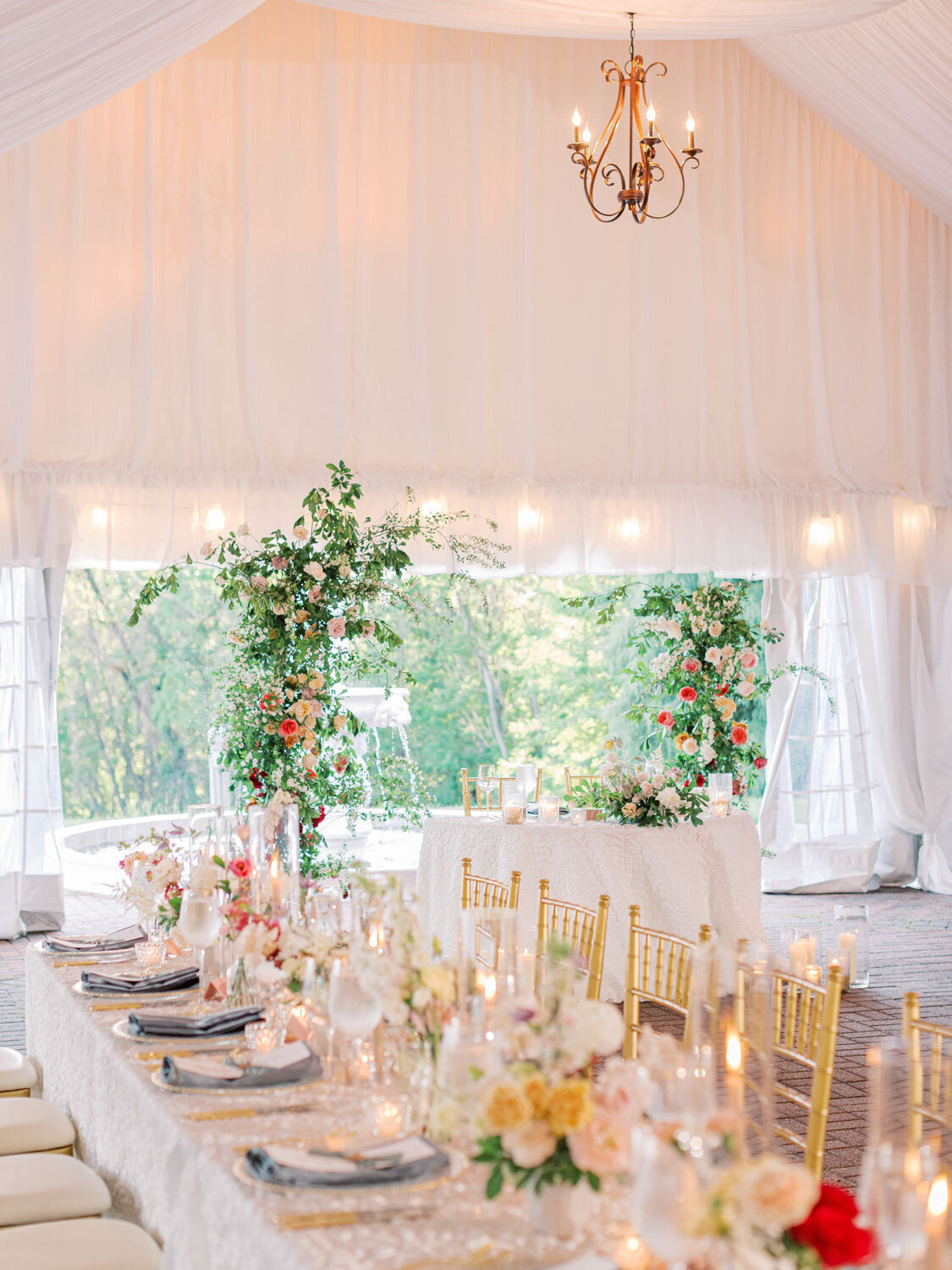 Elegant wedding reception designed with greenery and golden chairs