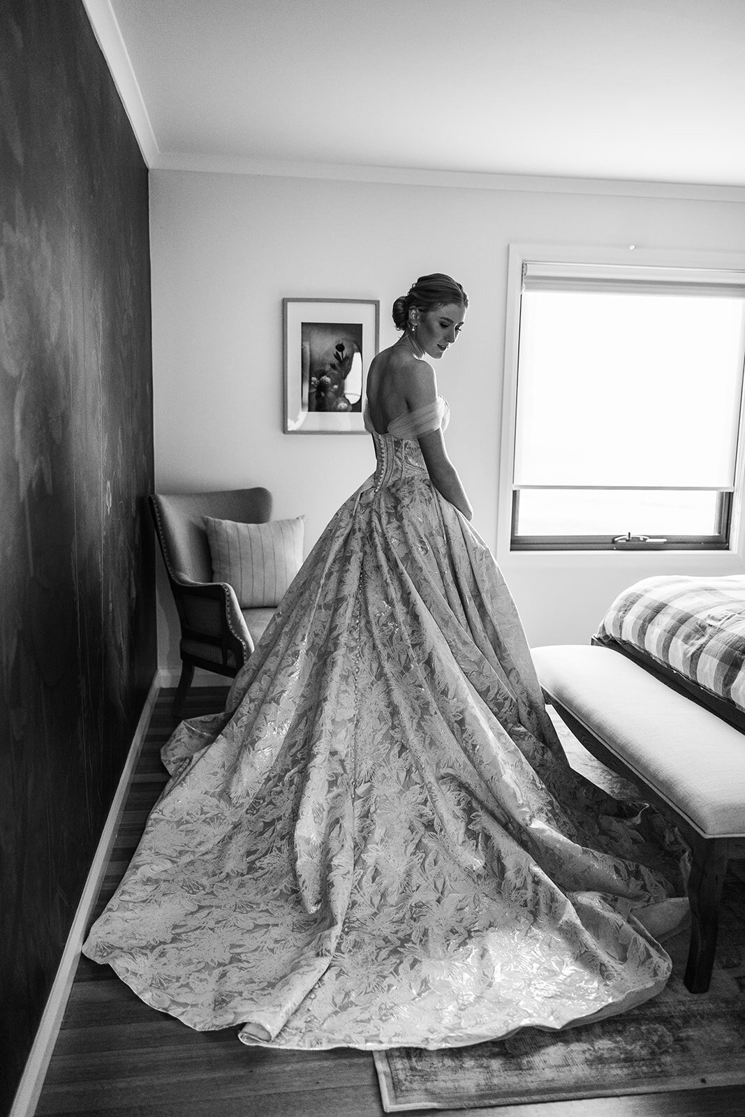 Bride admiring her wedding dress