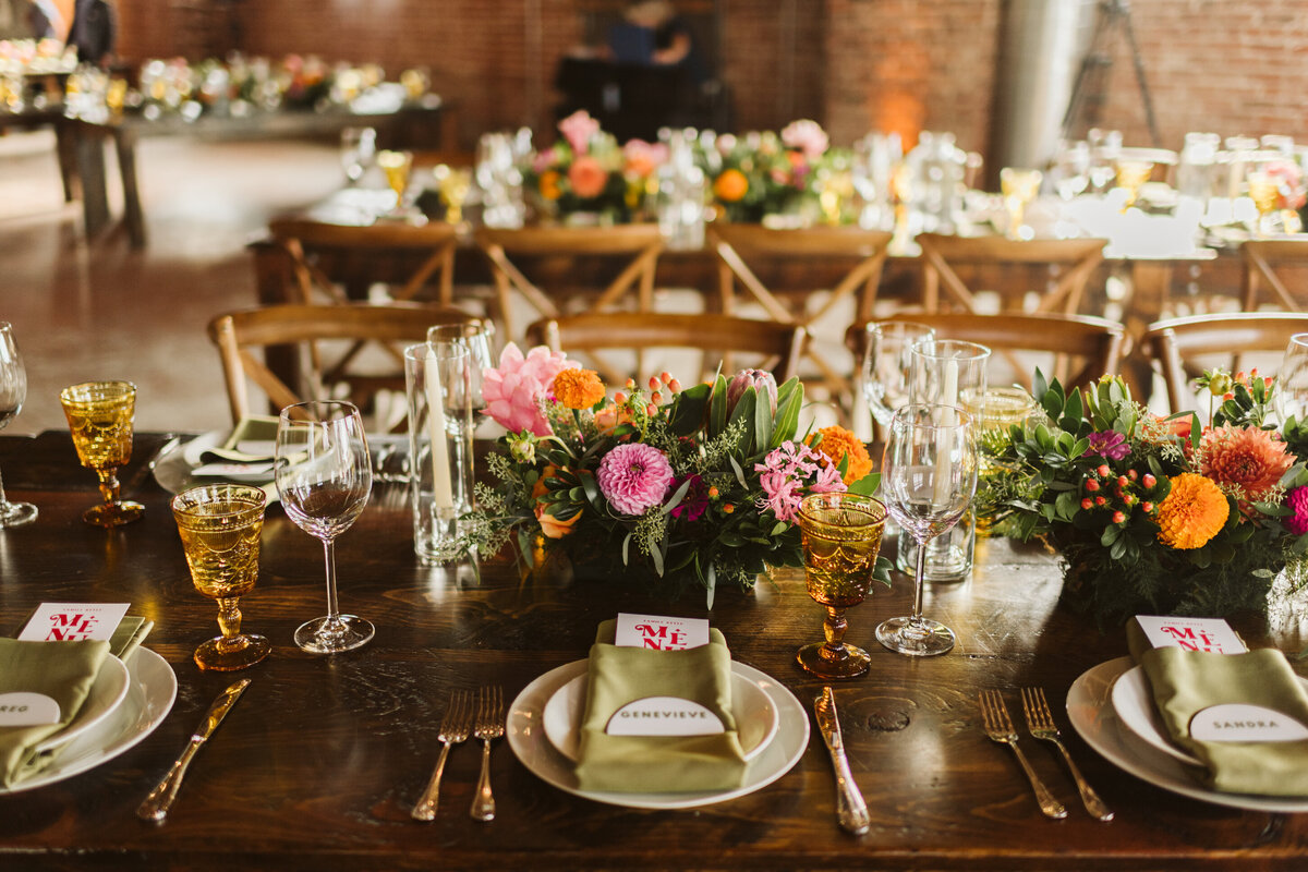 Wedding reception table decor with bright florals at the St Vrain wedding venue, Boulder county Colorado