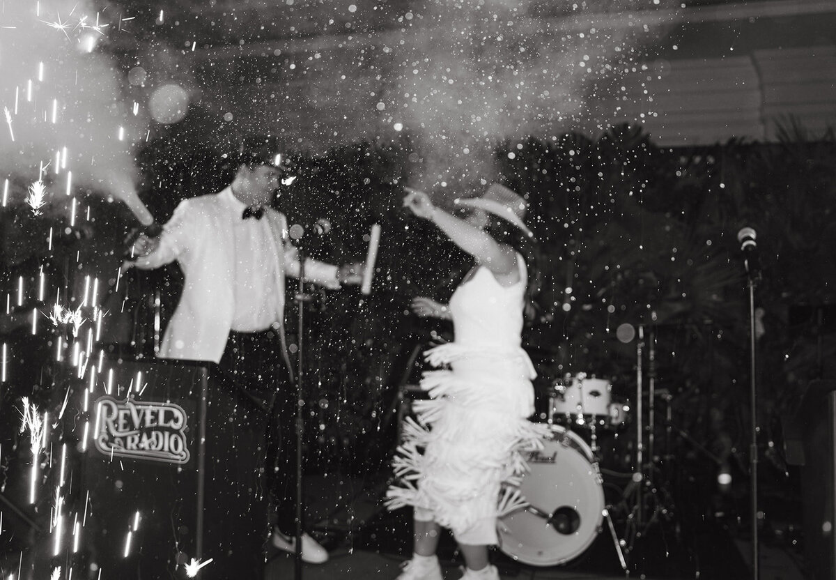 A black tie reception at The Ritz Carlton, Amelia Island. Couple enjoying their 17 piece band and Co2 cannons on stage, designed and coordinated by Amelia Island wedding planning experts, The Eventful Gals.