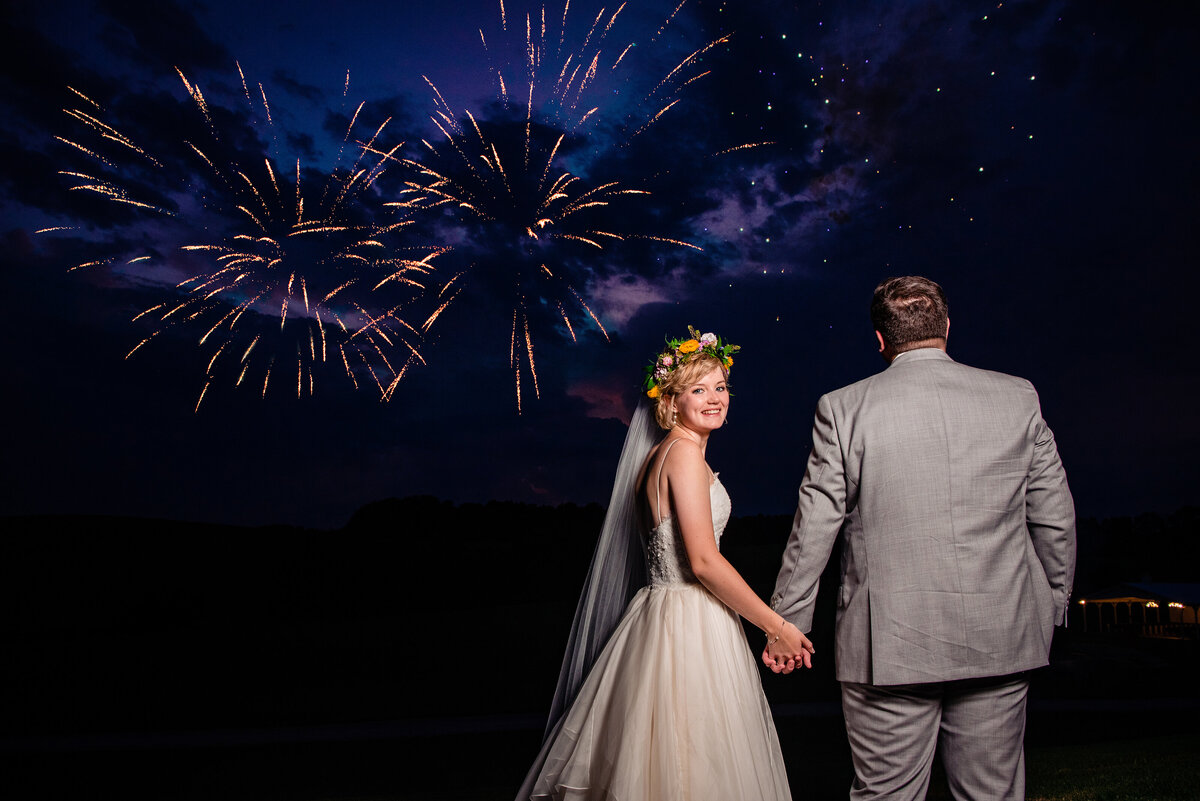 Bride and Groom watching fireworks during their reception at White Dove Barn