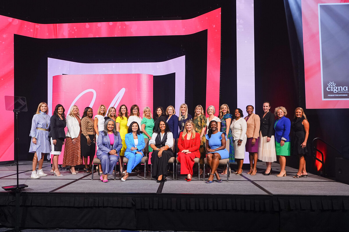 kansas-city-event-photography-0030-group-on-stage-with-red-and-white-backdrop
