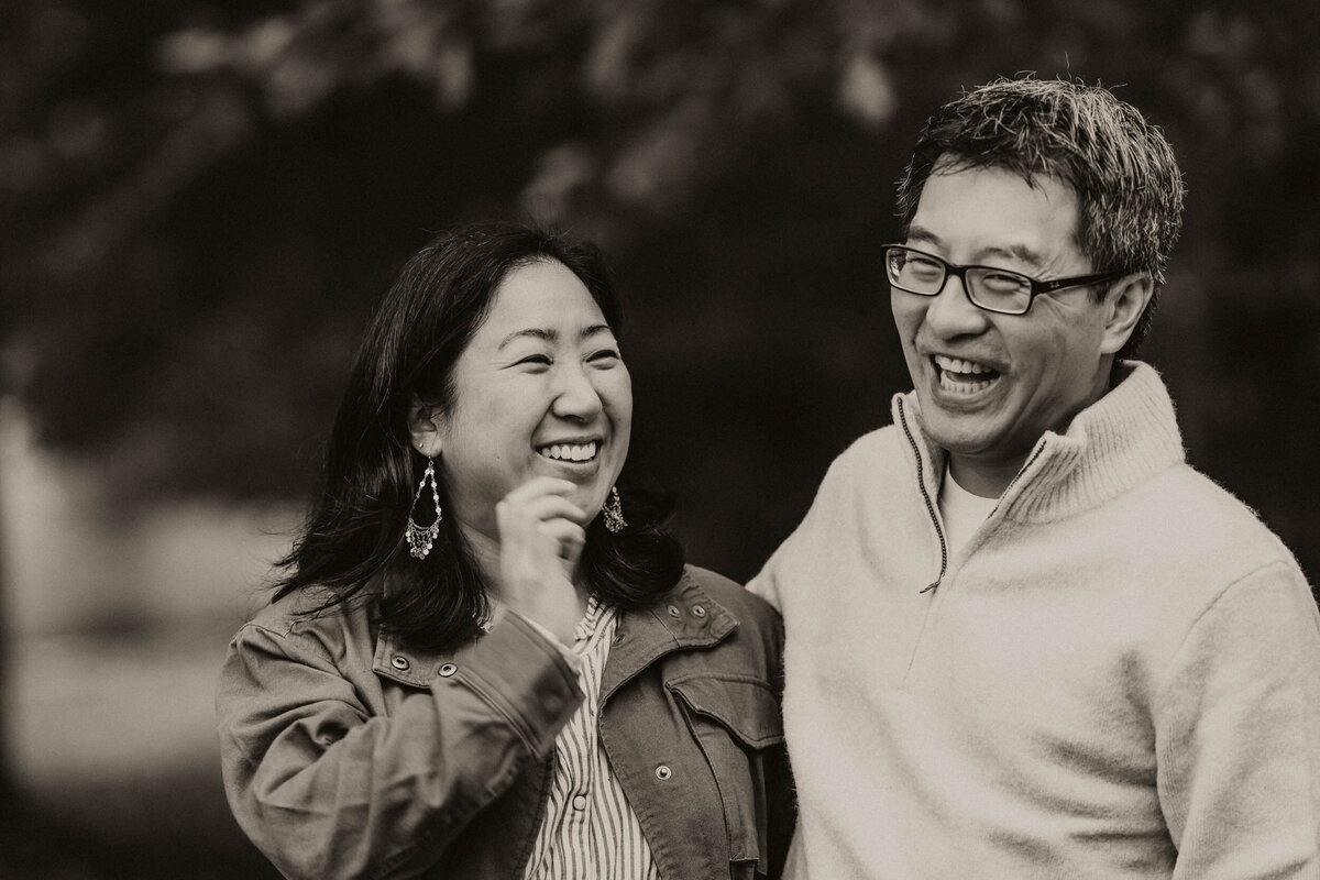 Heartfelt moment of a mother and father laughing together during a relaxed lifestyle session in Kirkland.