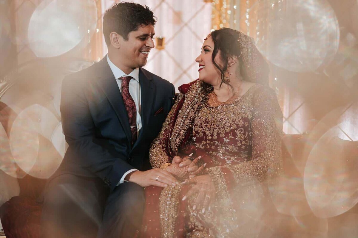 South Asian Bride and Groom sitting down and sharing a moment of solitude in Princeton New Jersey.