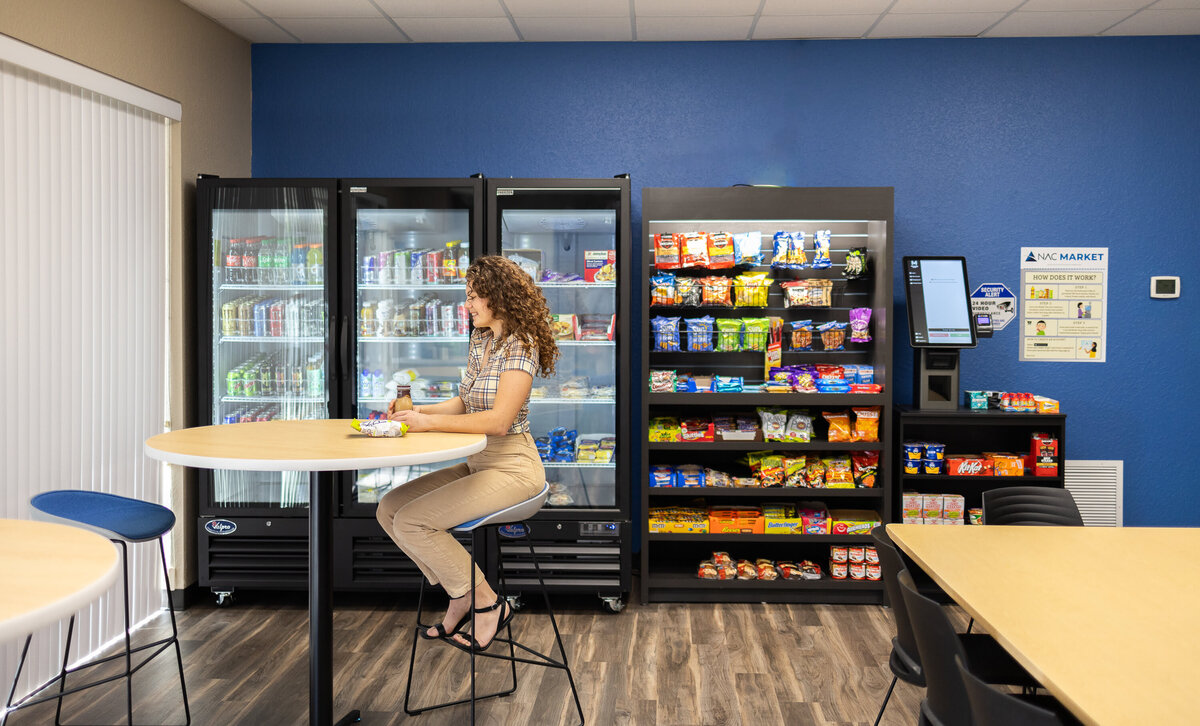 Employee in break room getting a snack from a vending machine at a micro market in Clearwater.