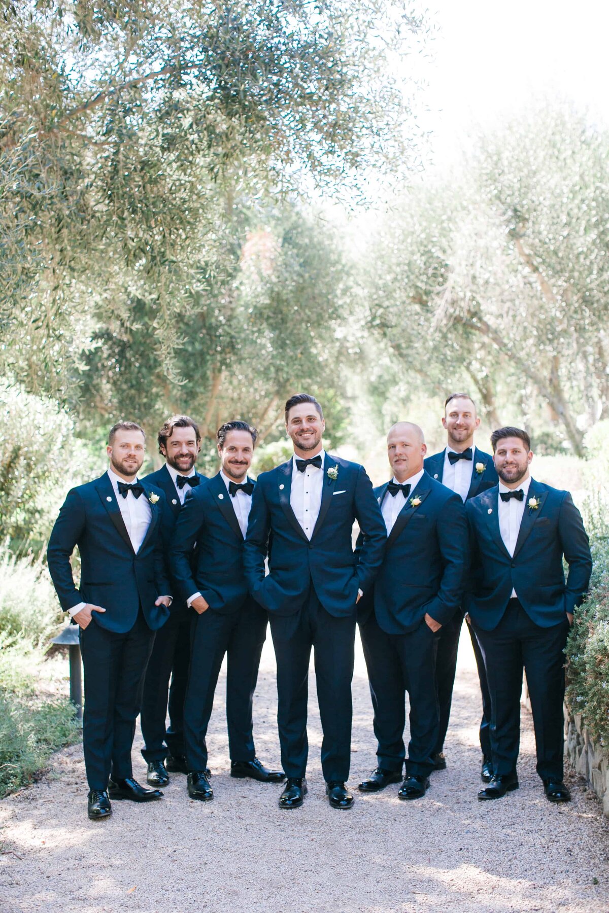 Groom and groomsmen at an outdoor wedding venue
