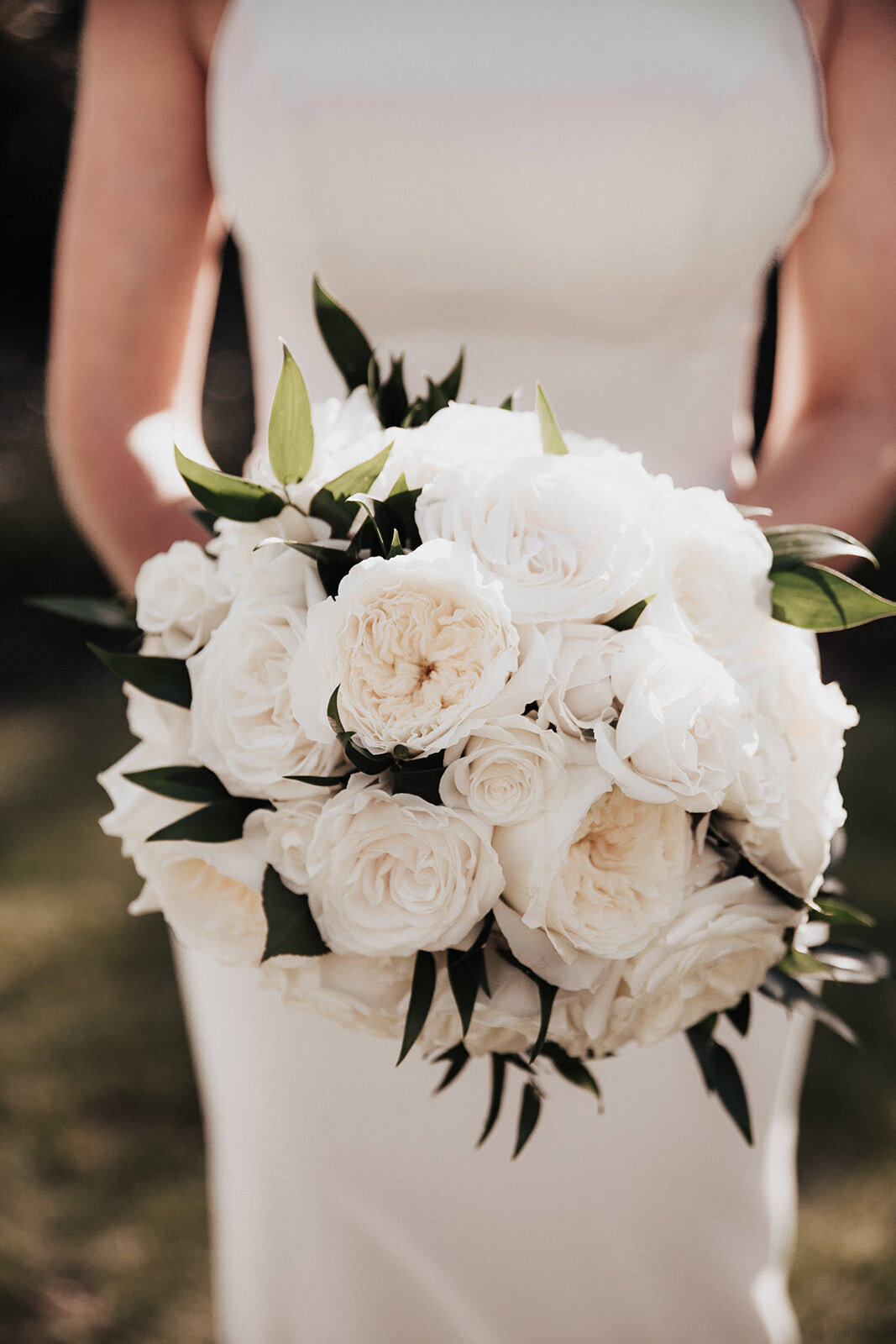 Bride showing bouquet with white roses