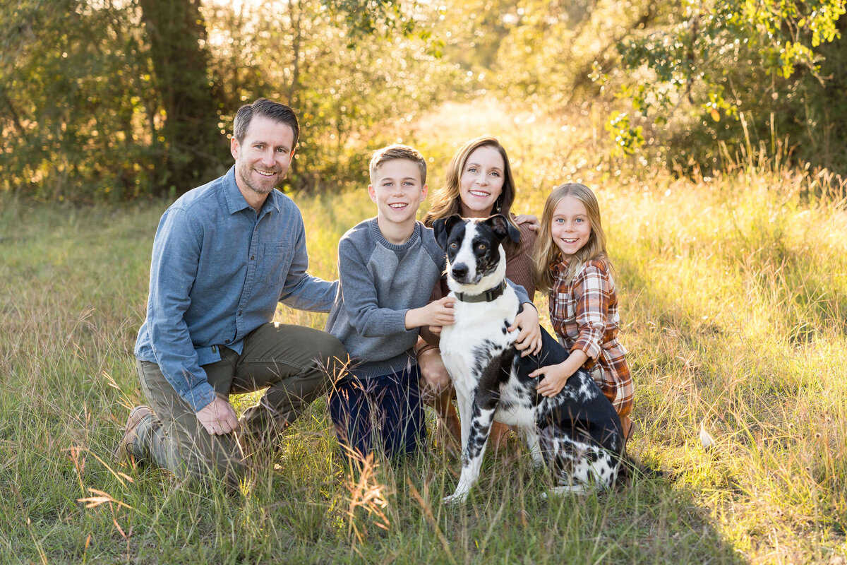 Family plays during a family photoshoot at Circle C Park in Austin, Texas.
