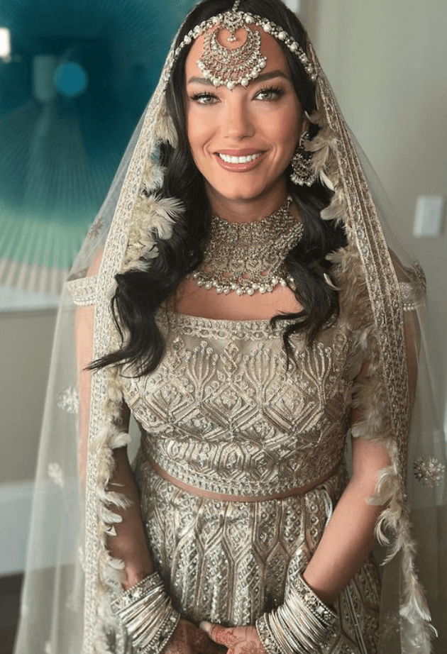 Bride in traditional South Asian attire with intricate jewelry and flawless wedding day makeup, styled by Mistique Makeup in San Antonio