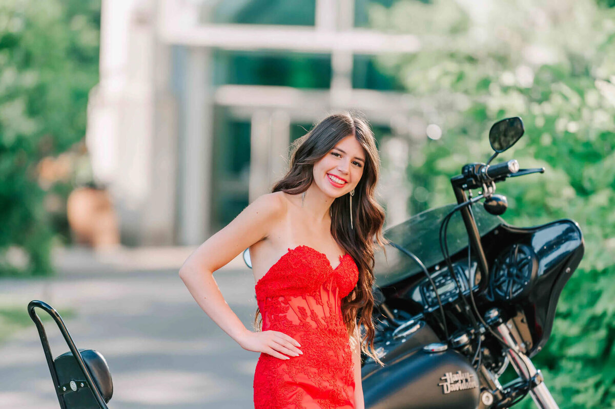 Waist up close up of the girl in front of the motorcycle. 