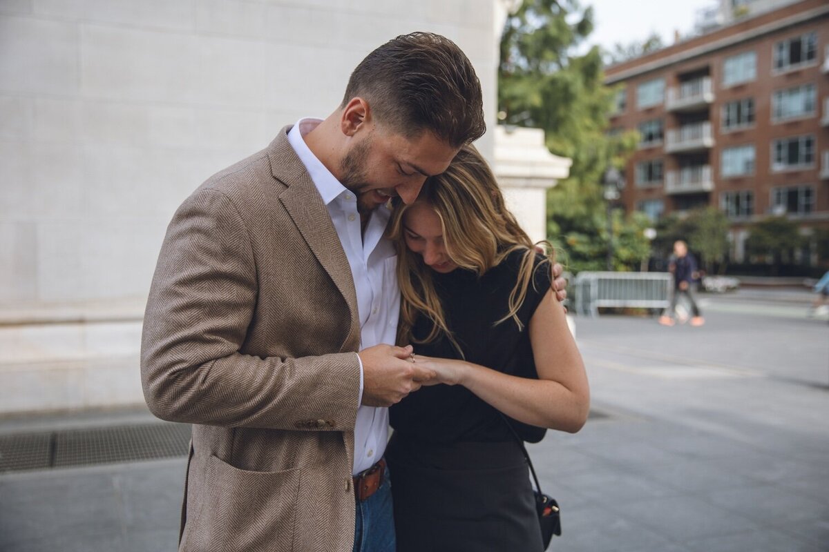 Couple admiring the engagement ring together.