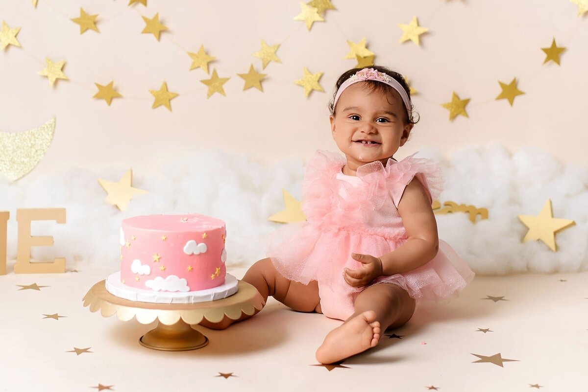 Dream theme cake smash with baby girl in pink.