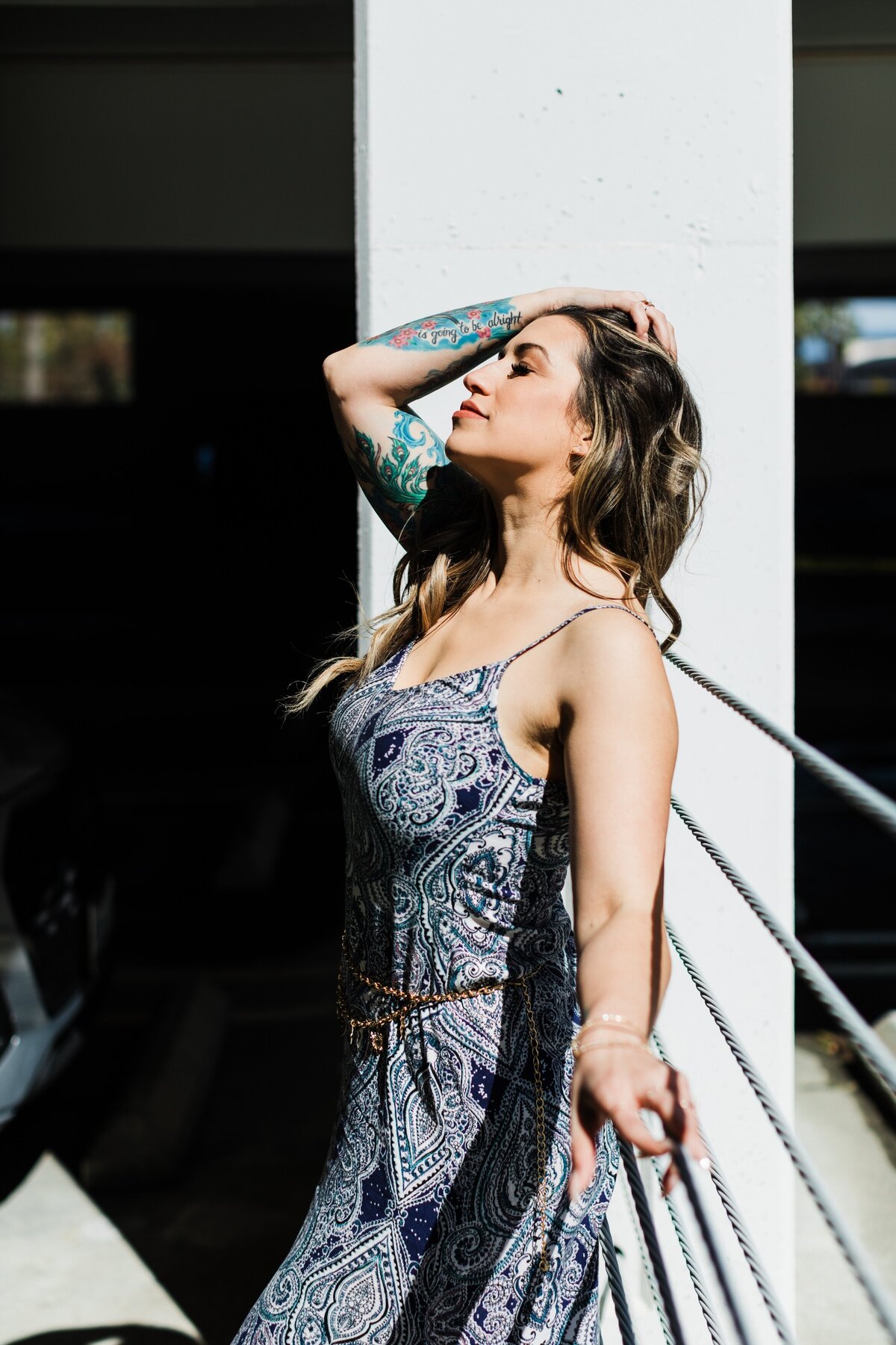 LA-woman-with-tatoos-standing-in-dramatic-light-in-torrance-parking-garage