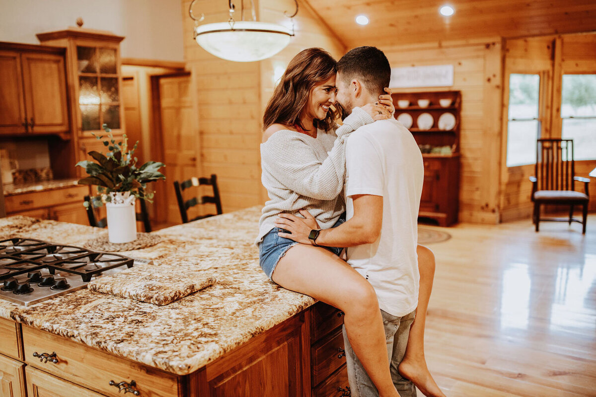 Couple sharing a cozy moment in a modern rustic kitchen