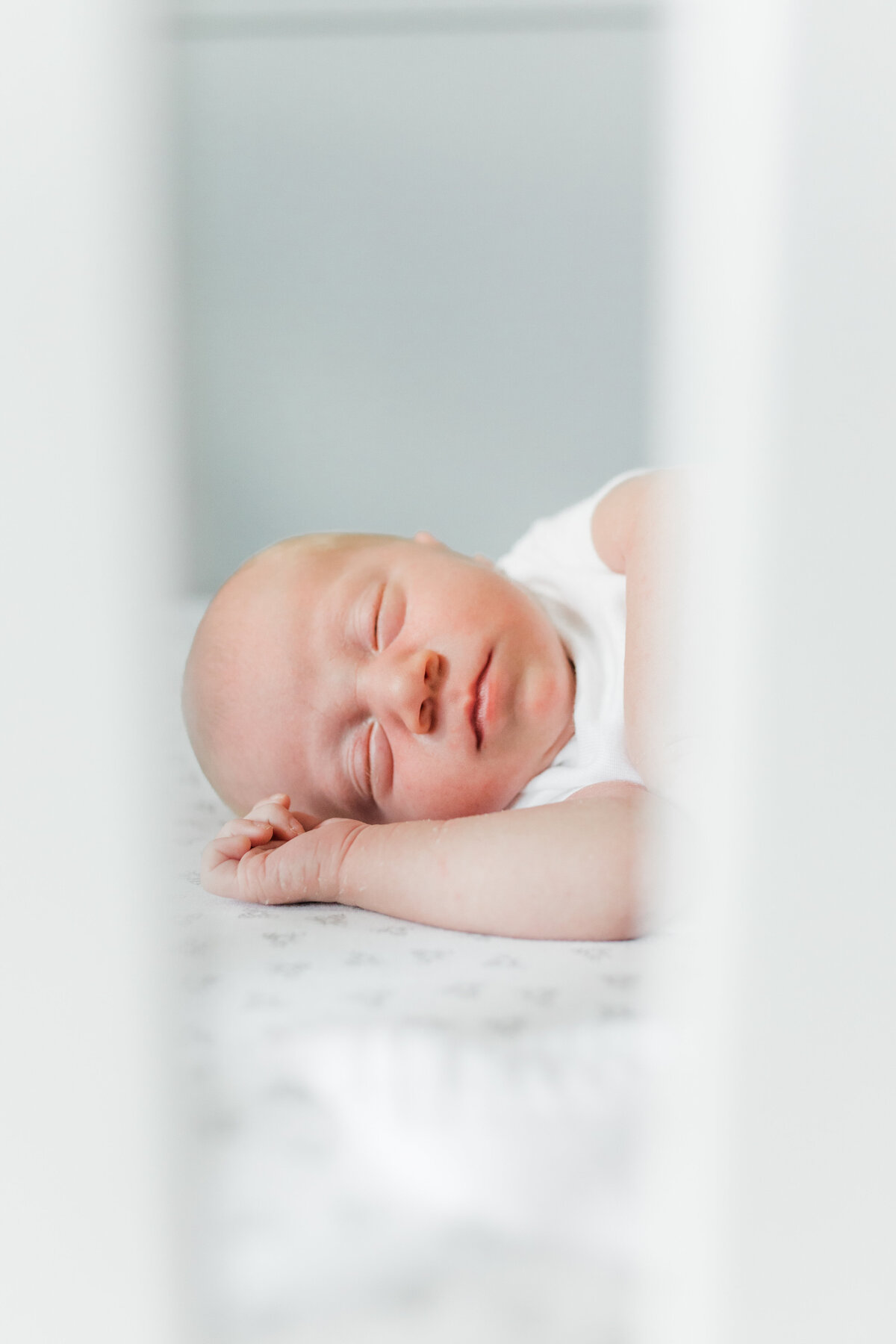 Sleeping newborn on a white blanket