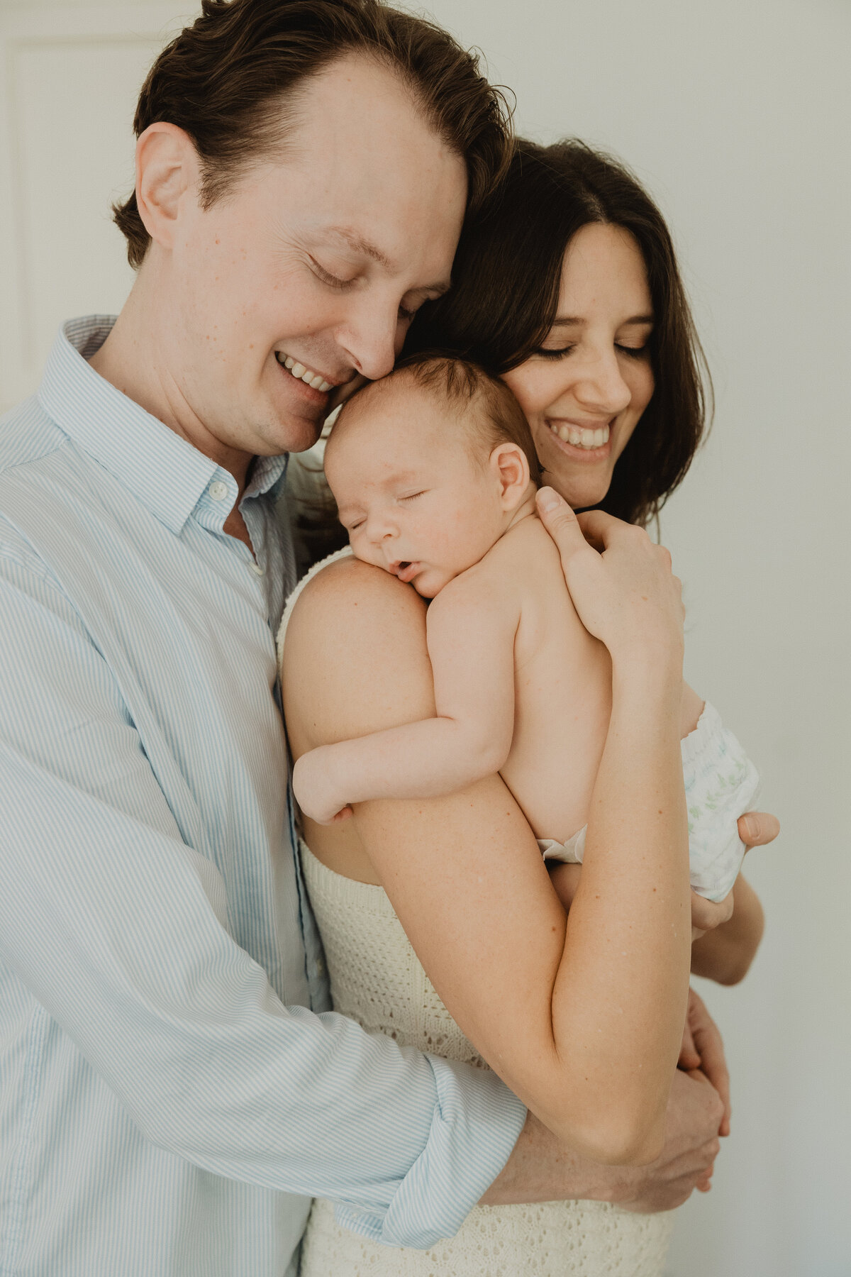 new-mom-and-dad-hold-baby