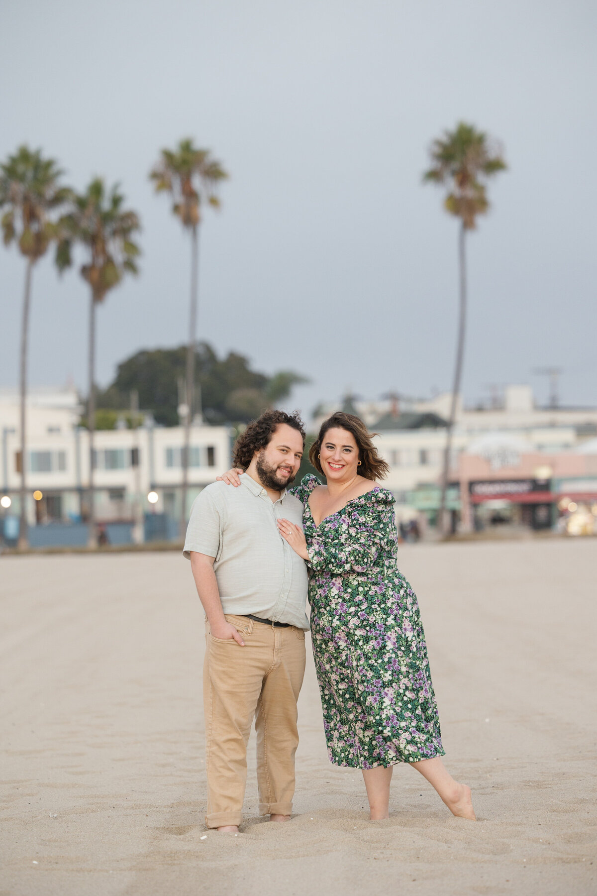 A person with her hand on her partner's chest as they both smile