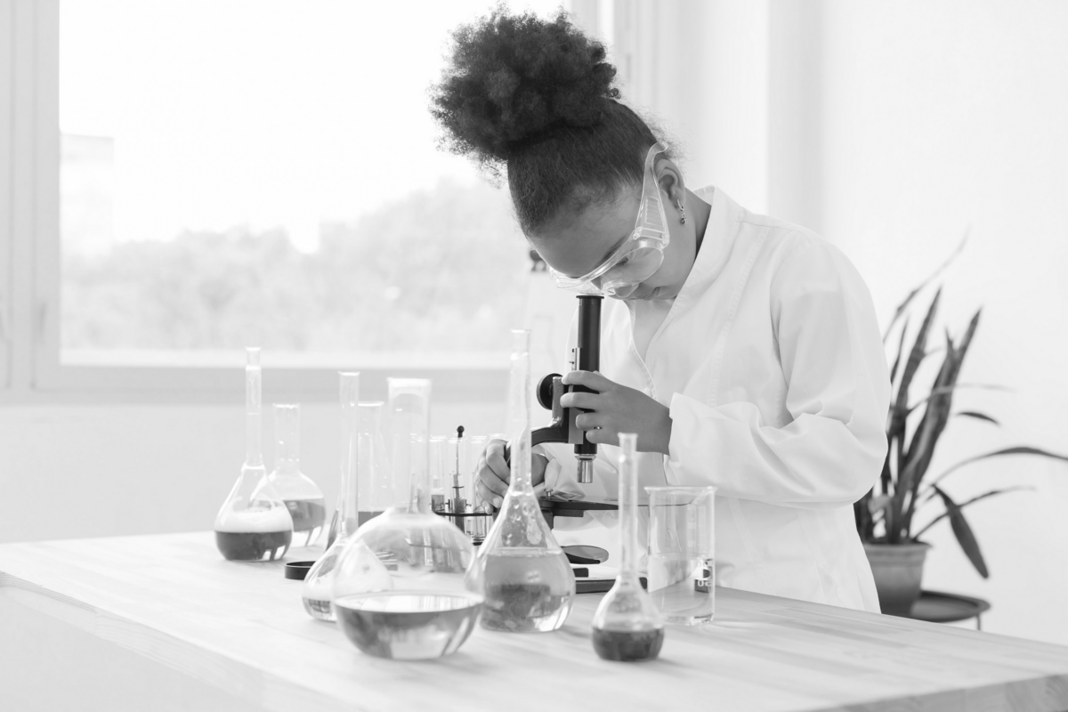 side-view-girl-scientist-looking-through-microscope