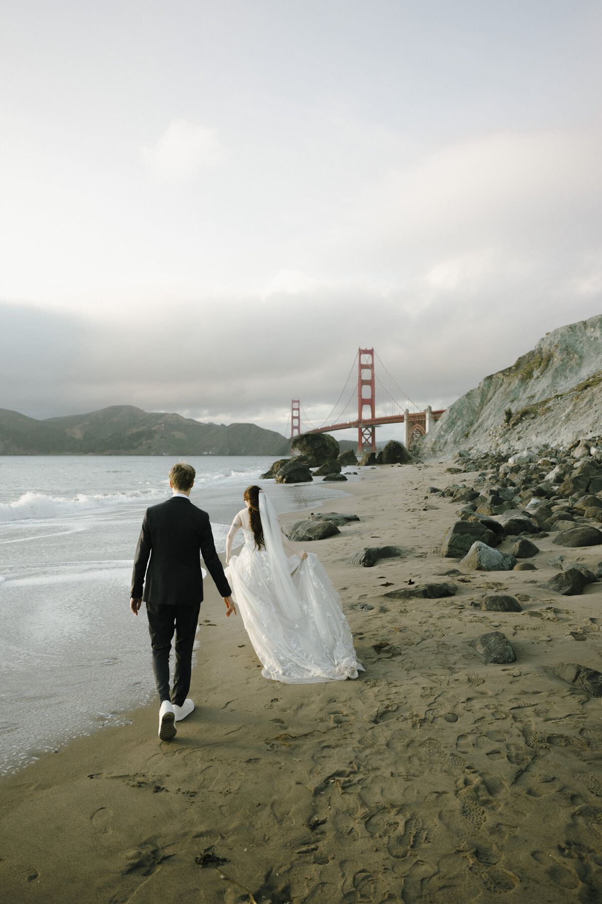 Bride and Groom at Marshall's Beach in San Francisco, California at sunset