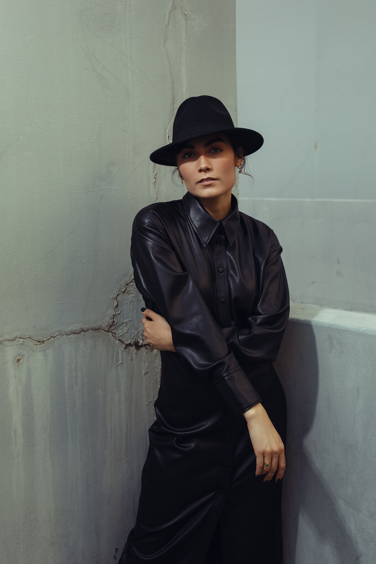 Portrait Photo Of Young Woman In Black Coat With One Hand On Her Waist Los Angeles