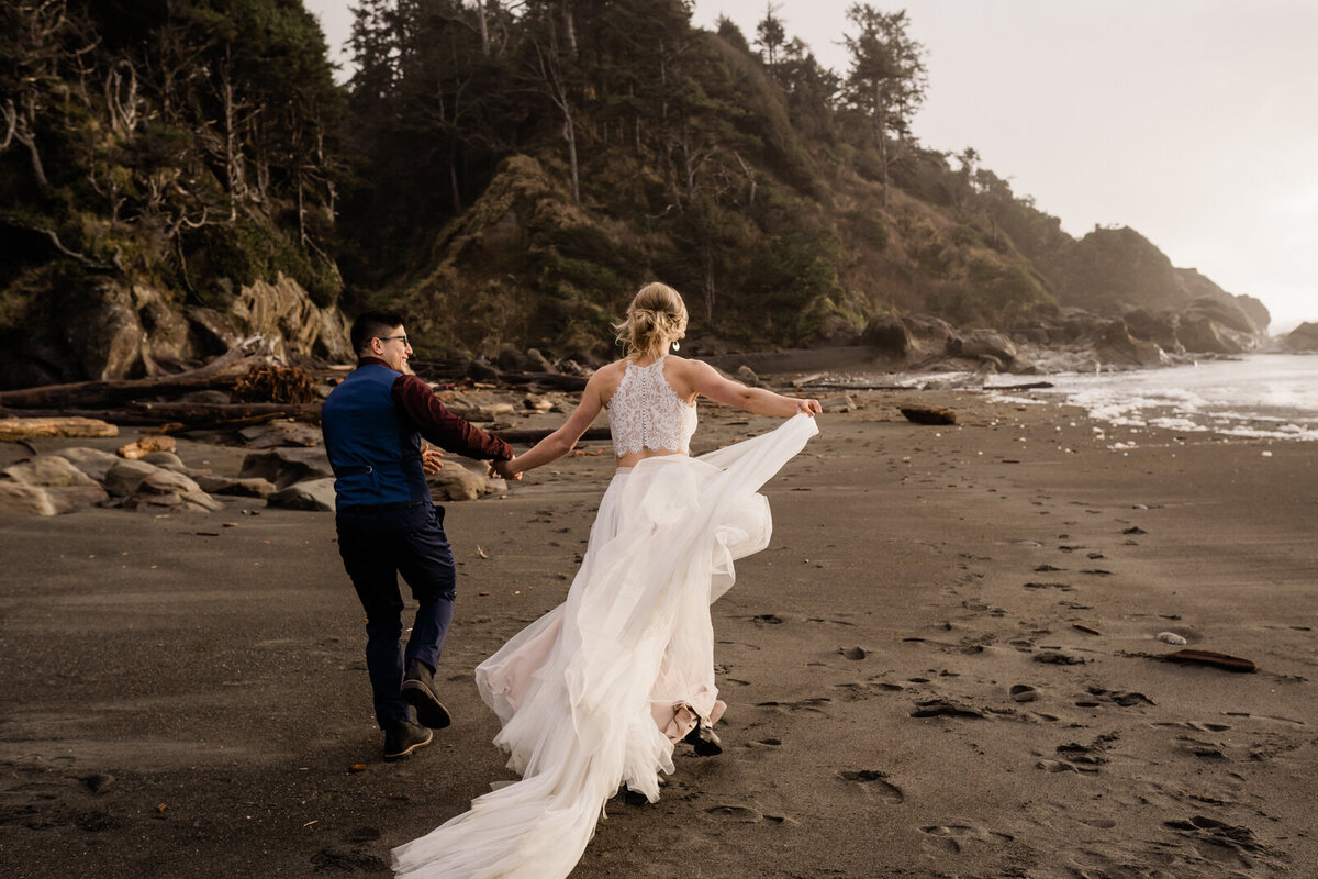 bride and groom walking across mountain scape