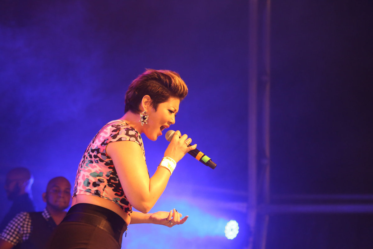 International star, Jamaican singer Tessanne Chin sings under purple lights. Photo by Ross Photography, Trinidad, W.I..