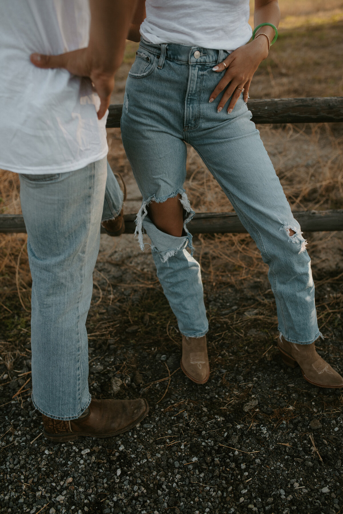 matching jeans and boots in front of picket fence