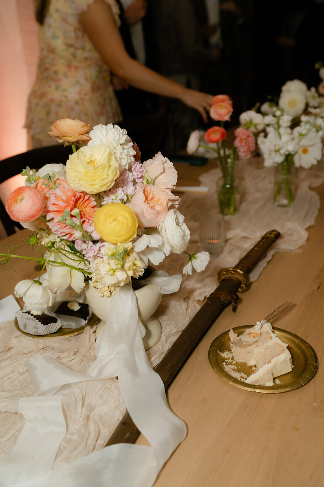 photo of the florals, bouquette and cake with the sabere
