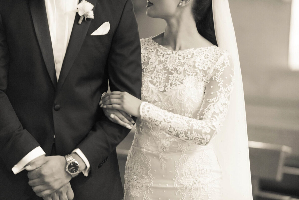 couple-getting-married-as-she-holds-his-arm