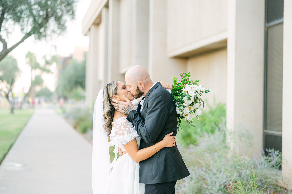 The bride and groom share a tender kiss during their downtown Phoenix elopement photo session.